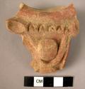 Pottery handle fragment - dark brown, relief and incised