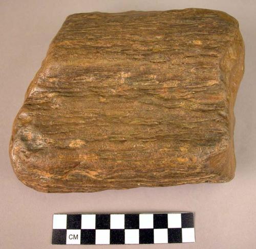 Massive double-ended hand adze of fossil wood