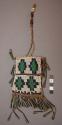 Small beaded leather purse with trade beads, metal tassels, and brass beads.