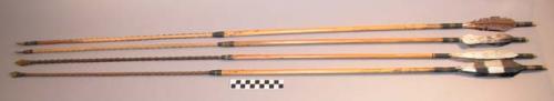 Stone pointed feather tipped wooden arrows with barbed foreshafts (4)