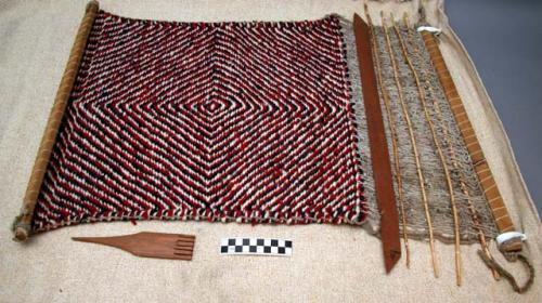 Small rug on loom, concentric diamond pattern; black, red and white