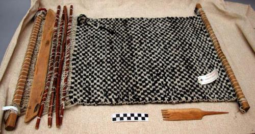Small rug on loom, alternating black and white squares