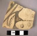 Ceramic body sherd, buff ware with black painted geometric design.