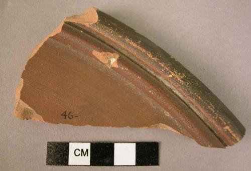 Ceramic plate sherd, fine ware, brown glazed int., ext. unglazed except for rim