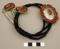 Bolo, grooved silver dome in the center, coral stones around edge & in center