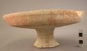 Carinate pottery bowl-hollow pedestal; painted band on foot; lugs on rim