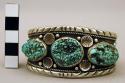 Cuff bracelet, silver band w/ stamped floral motifs, inlaid turquoise nuggets