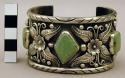 Cuff bracelet, silver band decorated w/ floral motifs, inlaid stones