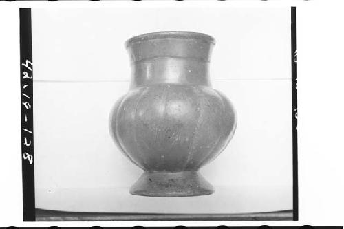 Plumbate standard jar on annular base, gadrooned. Ma.x ht. 14.3cm., max. diam. 1