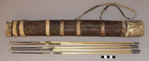 Wooden quiver with furskin caps at both ends; skin or furskin wrapped around qu