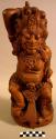 Carved wooden statuette of Boeta Sari, the bad god who became a good +