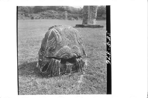 Stone figure (head missing) deliniated upon a boulder (Back)