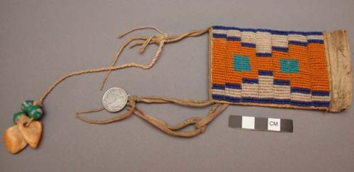 Small beaded pouch with teeth beads and small medallion