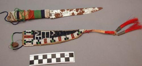 Knife and sheath. Front of sheath beaded mostly in blue and white