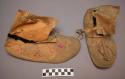 Pair of moccasins, possibly Sioux. Hard soles, soft uppers. Sewn up heel