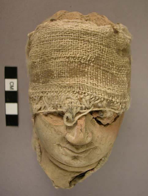 Figurine head; portion; baked clay.