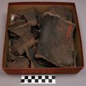 Broken earthenware pot (19 sherds); fire blackened