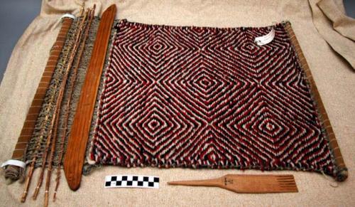 Small rug on loom,  concentric red, blue, and white diamond pattern