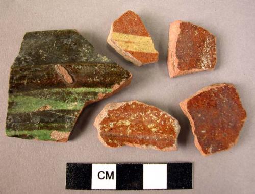 Ceramic rim and body sherds, brown and yellow; black and green glazed int.