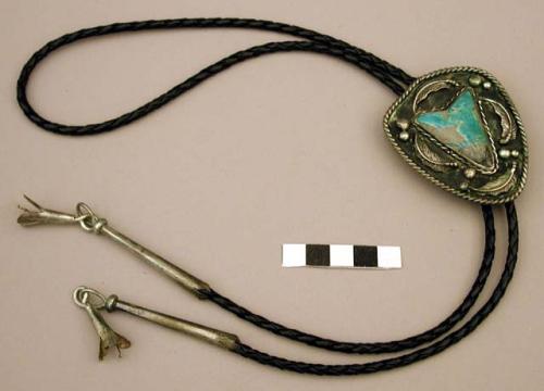 Bolo, silver shield w/ twisted wire around edge, center has inlaid "arrowhead"