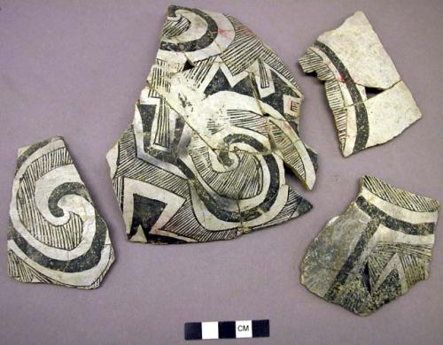 Ceramic; sherds - body; black on white geom. designs; mended