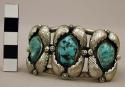 Silver cuff bracelet w/ 3 turquoise stones encircled by silver leaves