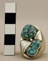 Silver ring, 2 turq. nuggets, 2 fan motifs & 1 silver bead between stones