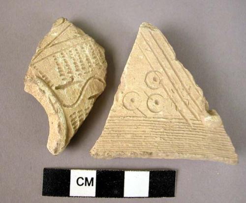 2 potsherds - light colored, buff, incised