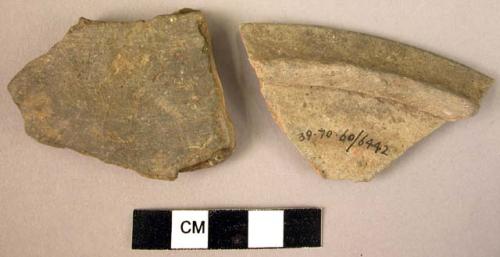 2 potsherds - plain grey; 1 fragment of lid