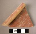 Israelite ware bowl rim- red paint on gray ware