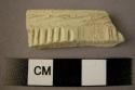 Ceramic rim sherd, white ware, wheel made, impressed and incised