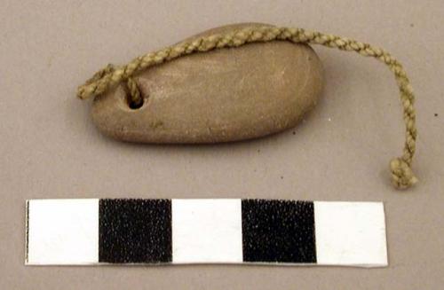 Ground stone pendant, tied with cordage