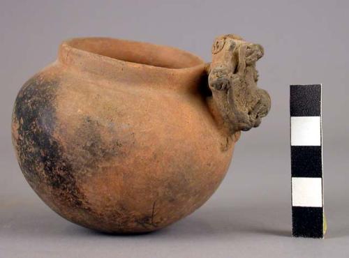 Pottery jar, handles connected with lip, plastic work and rudely carved to