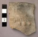 Ceramic rim sherd, incised and raised lug design, greyish, cracked