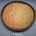 Woven straw dish with cow dung plastered on back - 14" long +