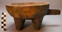 Wooden bowl with four legs and a handle.  Urubiga Ewamakwe