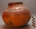 Red pottery vessel with incised  and black designs. Nsuku