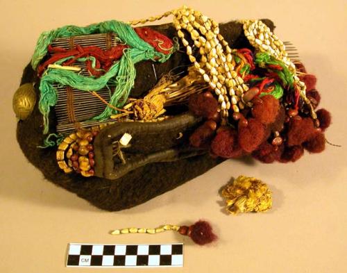 Woman's hat trimmed with natural flowers and feathers