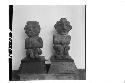 Front of two small stone figures