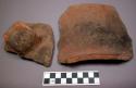 Ceramic sherds, orange, fireclouded?, 1 rim, 1 body with wide strap handle
