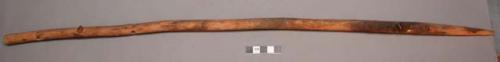 Wood, Prayer stick, pointed at one end, 3 perforations, fragment of cane in midd