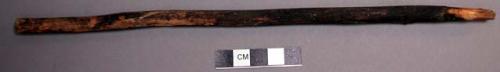 Wood, Prayer stick, pointed at one end, painted black with unpainted point
