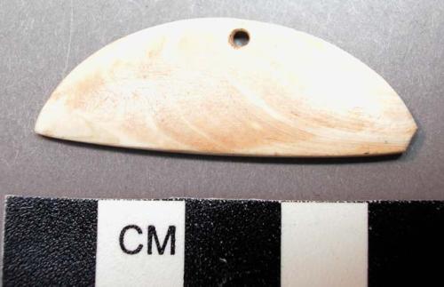 Piece of carved shell with perforation. diameter: 4.2 cm.