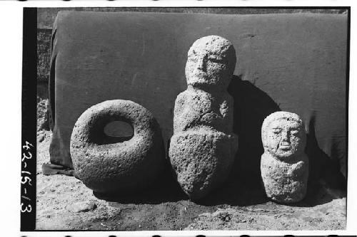 3 objects at left "manopla" of stone. Others two crude stone statues