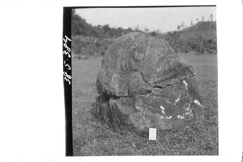 Stone figure (head missing) deliniated upon a boulder (Back & Right side)