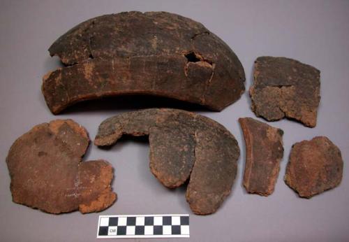 Ceramic sherds, some partially reconstructed, brown, rough exterior