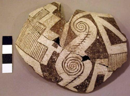 Ceramic rim sherd, black on white geometric design, mended, sherds missing