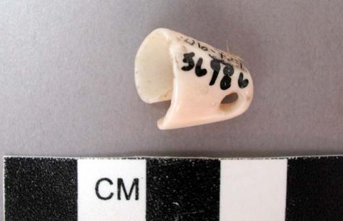 Worked conus shell, cone shaped with perforation near apex - 1.4 cm. length