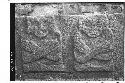 Stone slab with 2 seated figures with arms crossed over breast