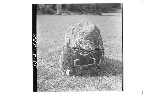 Stone figure (head missing) deliniated upon a boulder (Front)